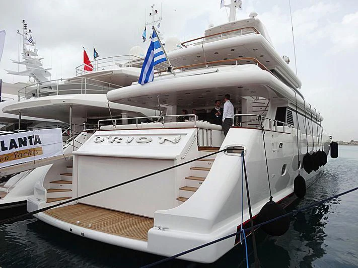 a large white boat with flags on it aboard O'RION Yacht for Charter