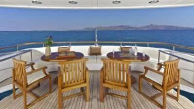a deck with chairs and tables on it aboard O'RION Yacht for Charter