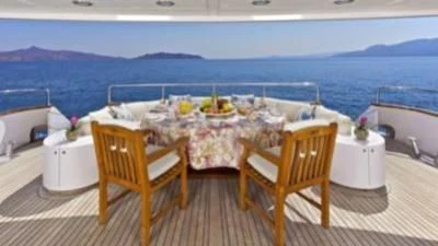 a table with chairs and a view of the ocean aboard O'RION Yacht for Charter