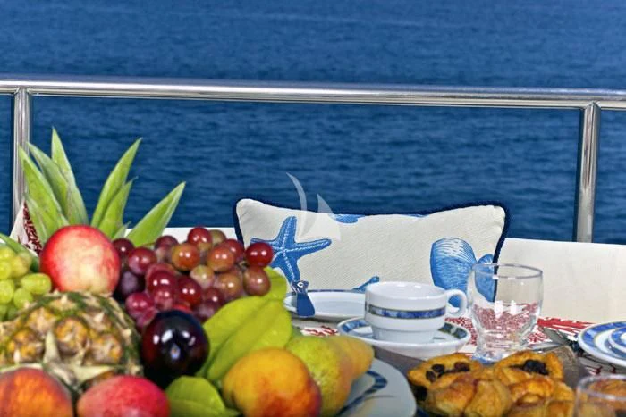 a table with food on it aboard O'RION Yacht for Charter