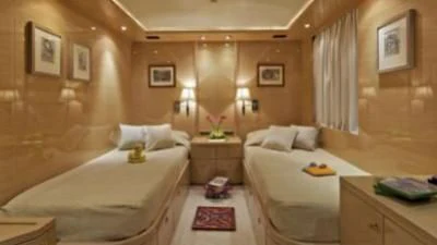 a room with a bed and a desk aboard O'RION Yacht for Charter