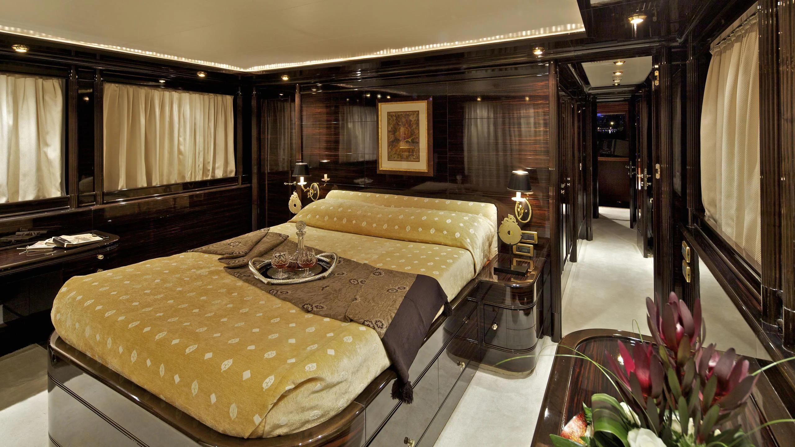 a hotel room with a bed and a table aboard O'RION Yacht for Charter