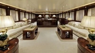 a large room with a couch and a piano aboard O'RION Yacht for Charter