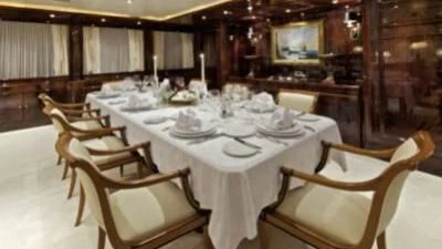 a dining room with a table set aboard O'RION Yacht for Charter