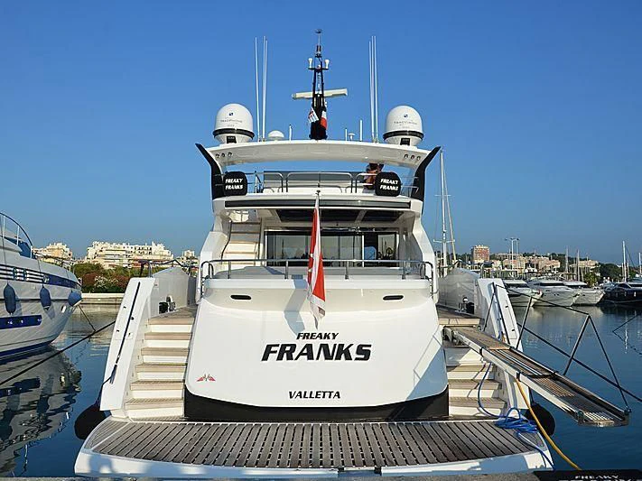 a large white boat in a harbor aboard FREAKY FRANKS Yacht for Sale