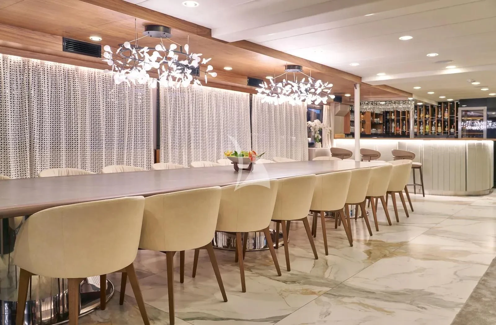 a long table with chairs around it aboard AETERNA Yacht for Sale