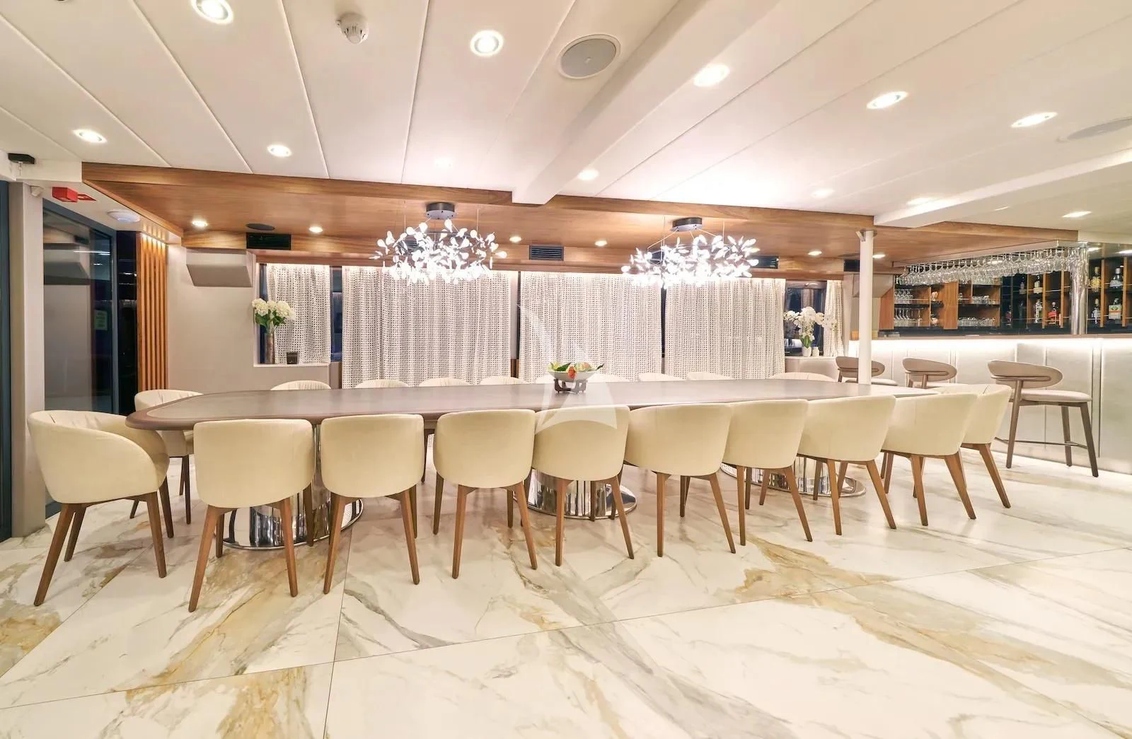 a room with a table and chairs aboard AETERNA Yacht for Sale