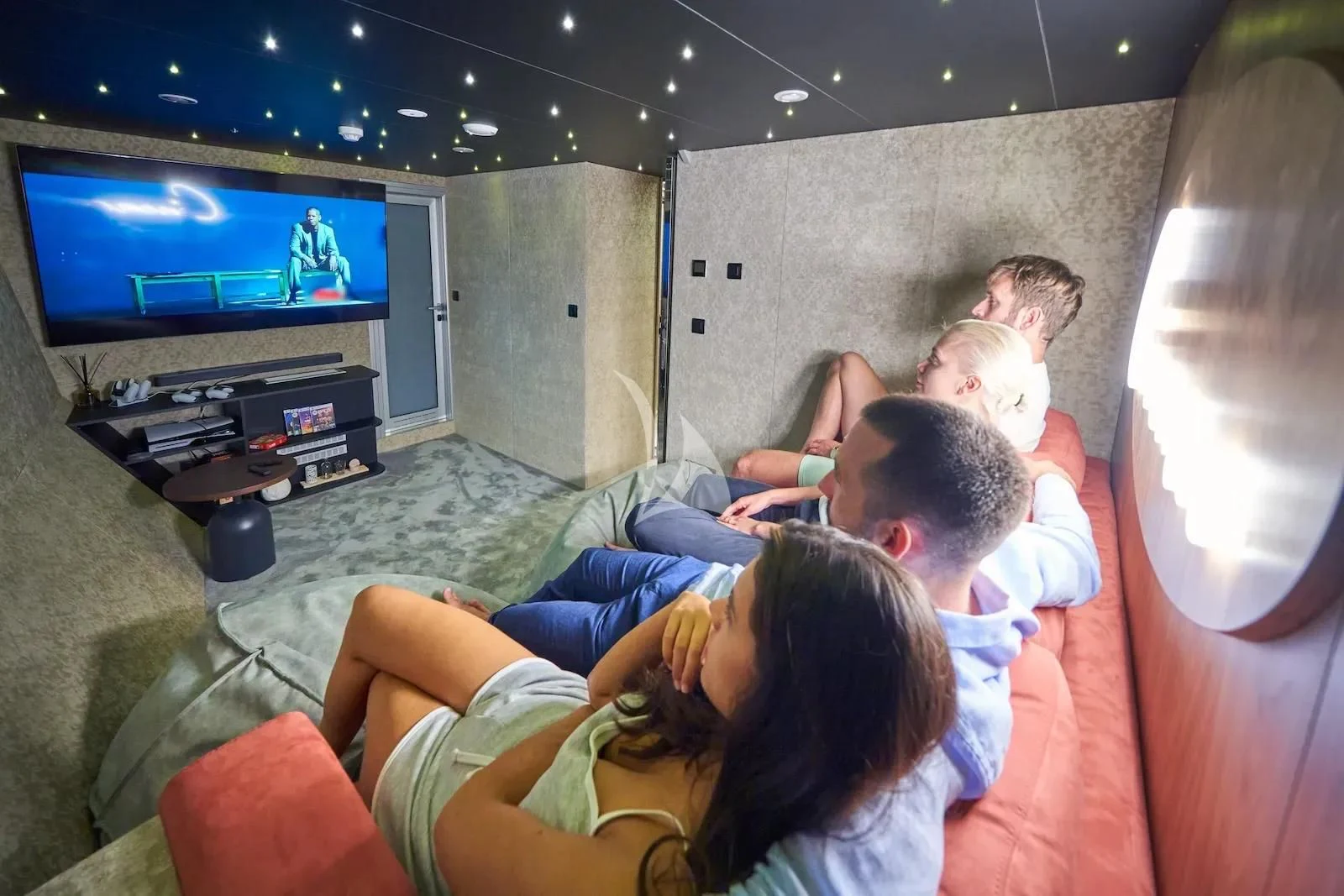 a group of people watching a television aboard AETERNA Yacht for Sale