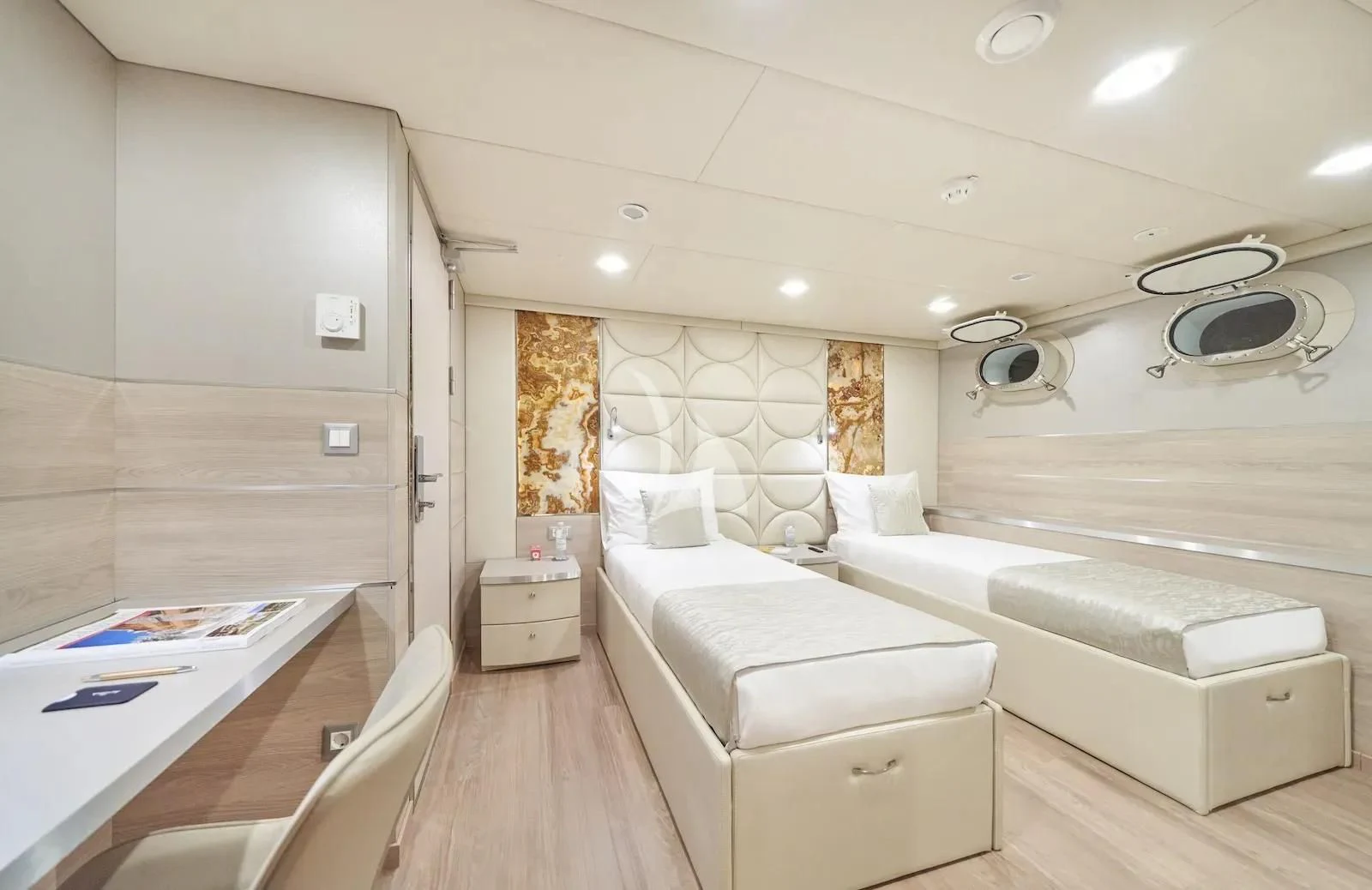 a room with a bed and a table aboard AETERNA Yacht for Sale