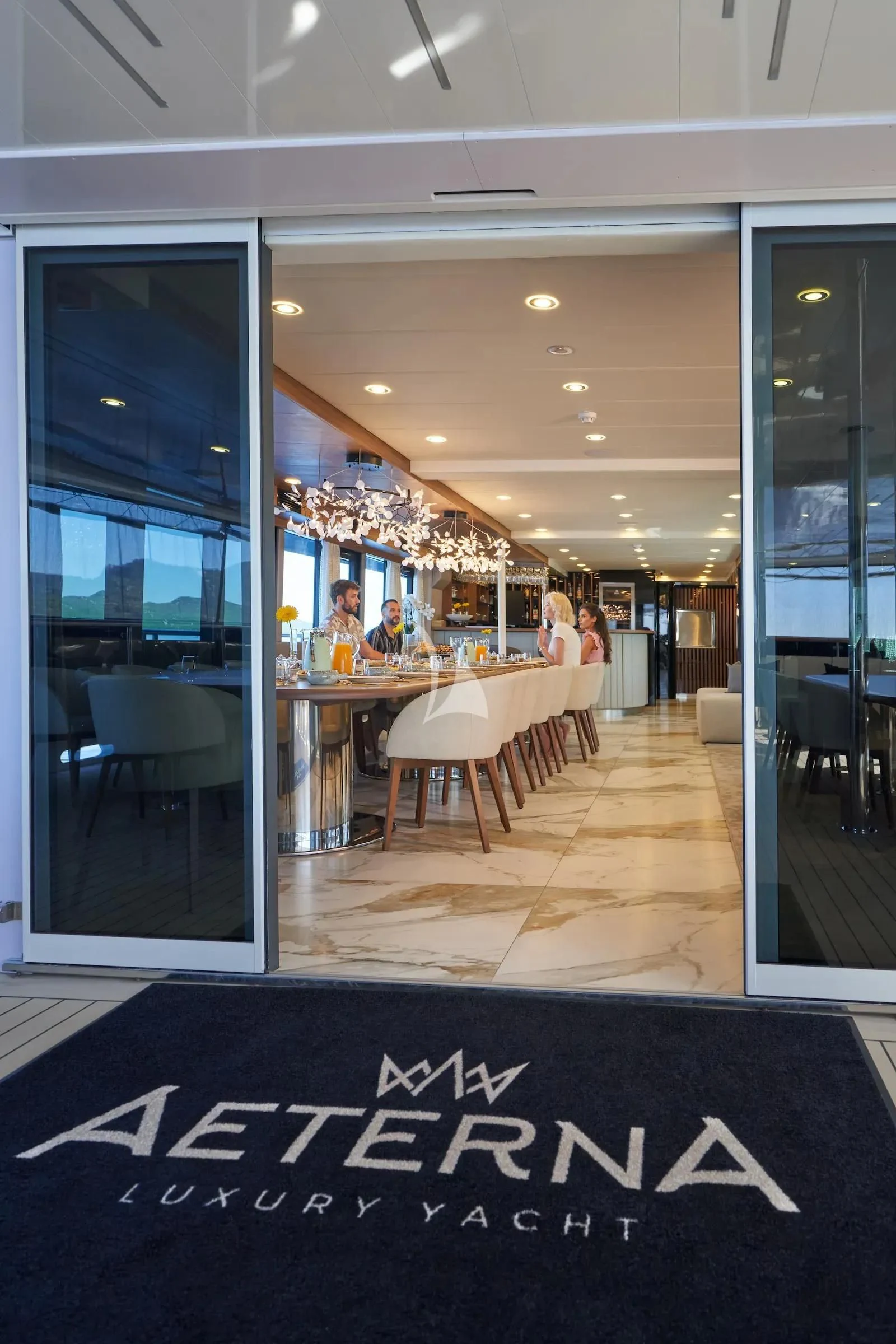 a restaurant with tables and chairs aboard AETERNA Yacht for Sale