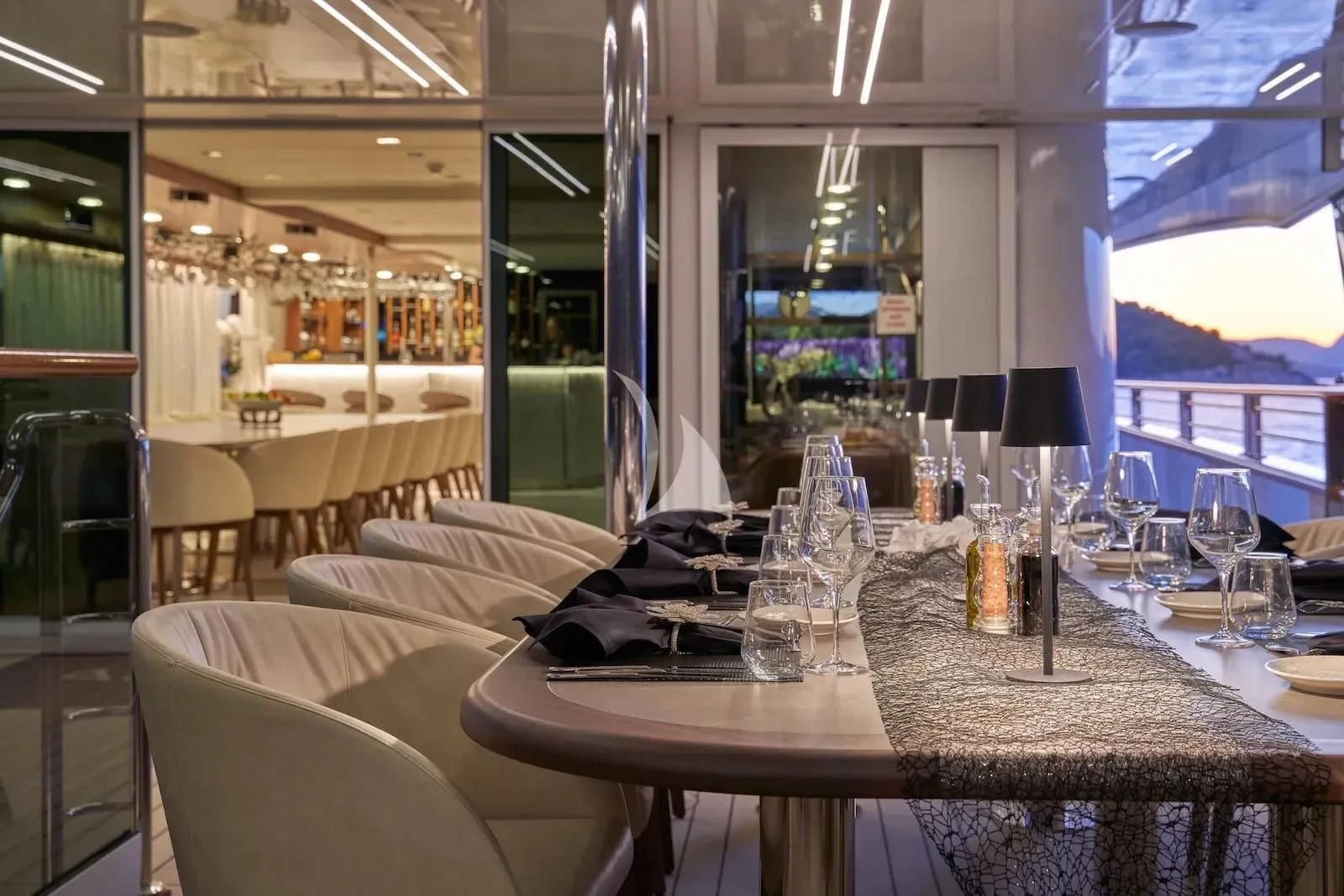 a table with chairs and a large window aboard AETERNA Yacht for Sale