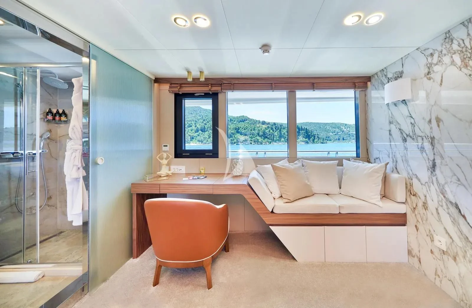 a bedroom with a bed and a chair aboard AETERNA Yacht for Sale