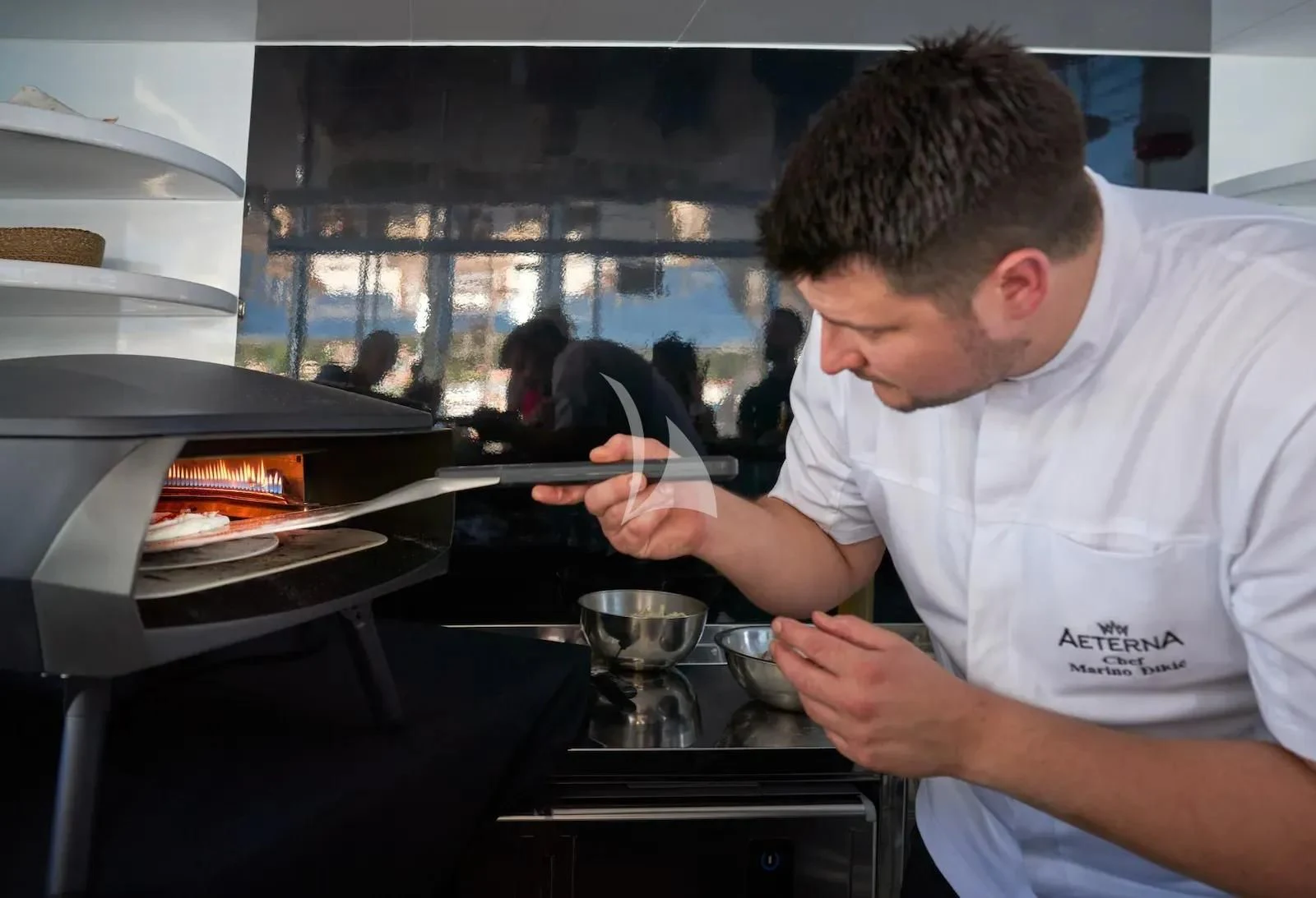 a person using a tablet aboard AETERNA Yacht for Sale