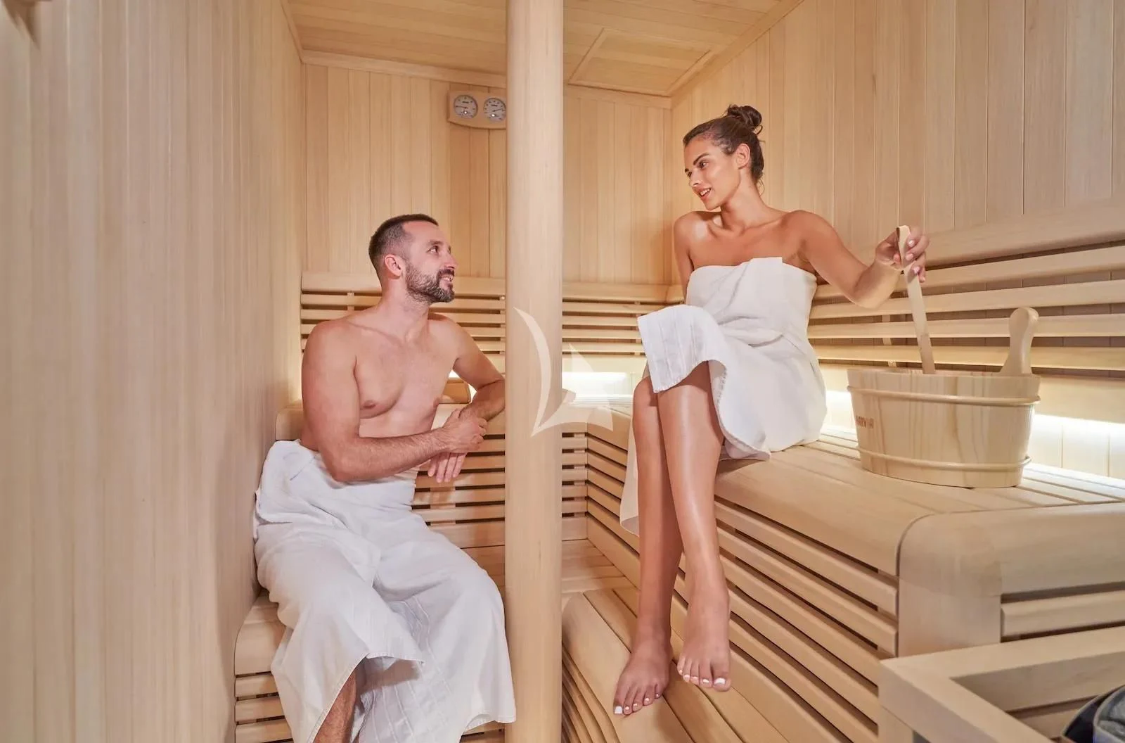 a man and a woman sitting on a bench aboard AETERNA Yacht for Sale