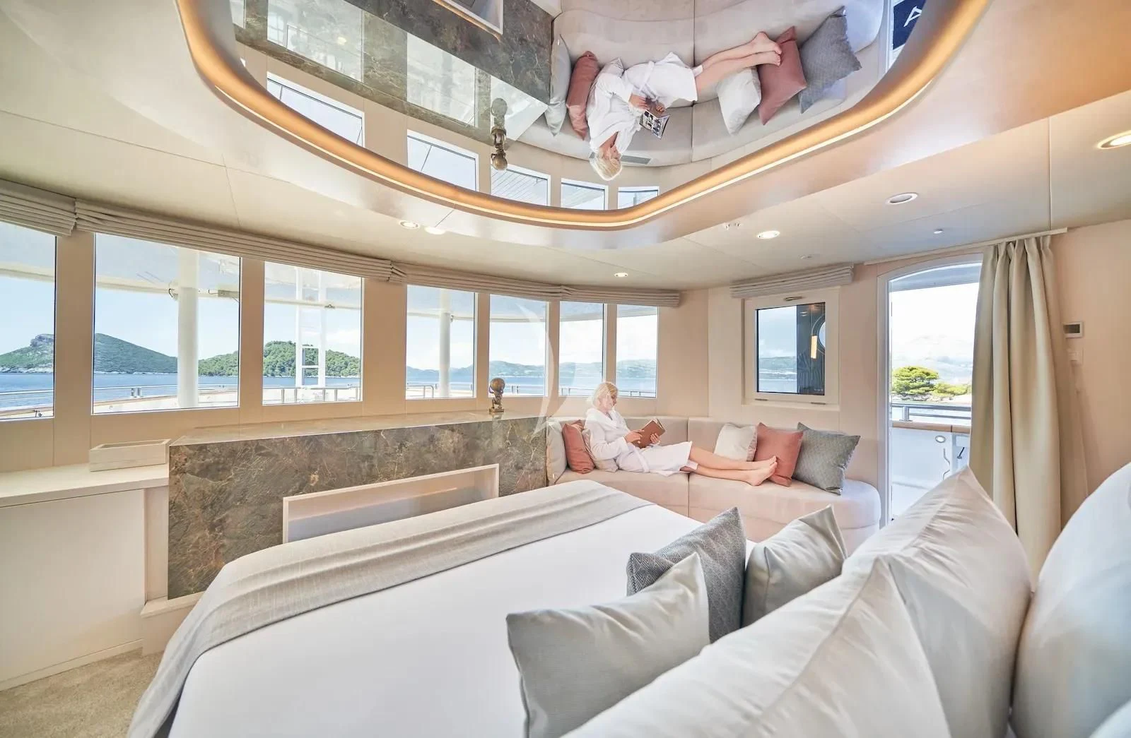 a room with a couple of people on the couch aboard AETERNA Yacht for Sale