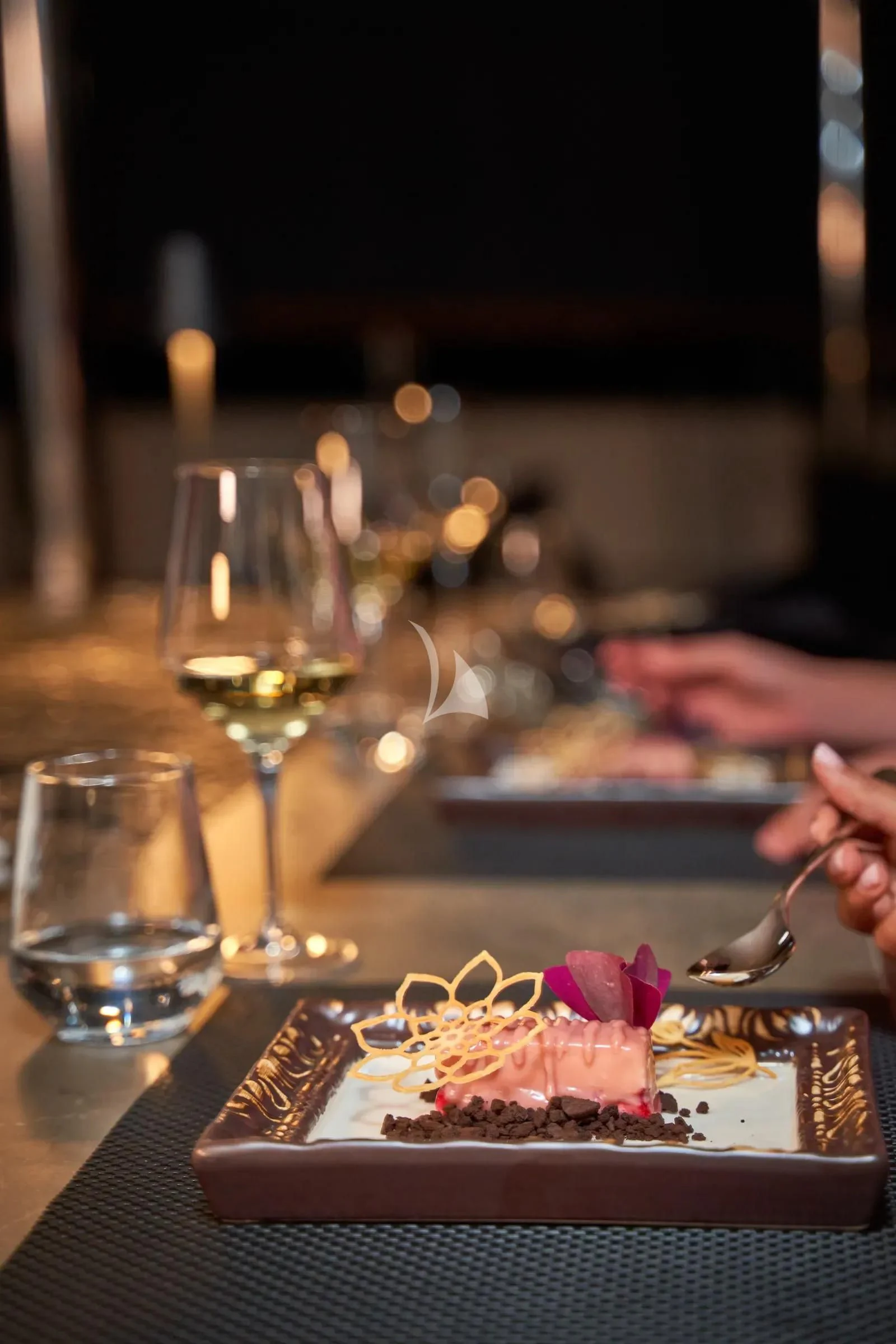 a plate of dessert and glasses aboard AETERNA Yacht for Sale