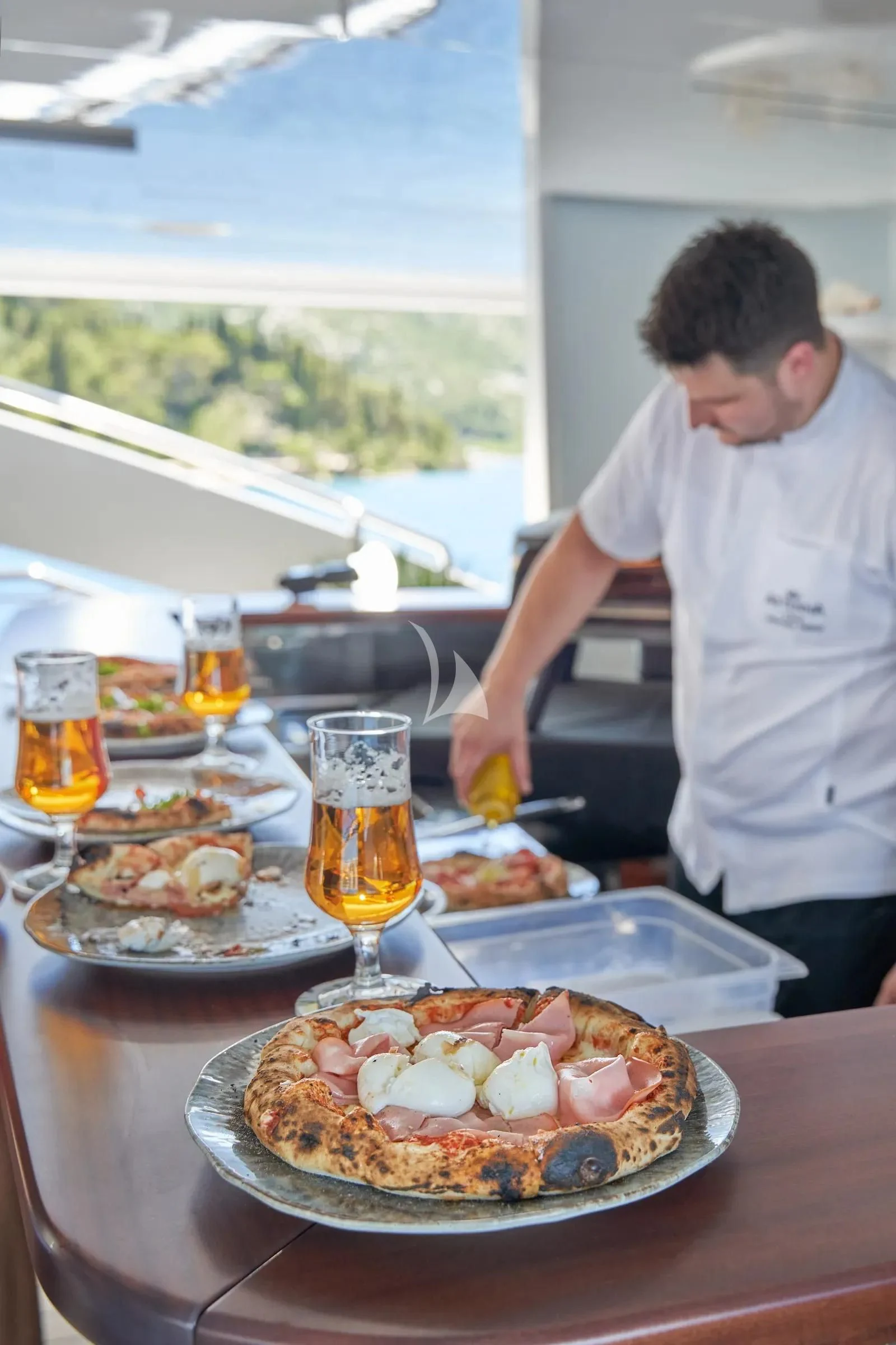 a person preparing food on a table aboard AETERNA Yacht for Sale