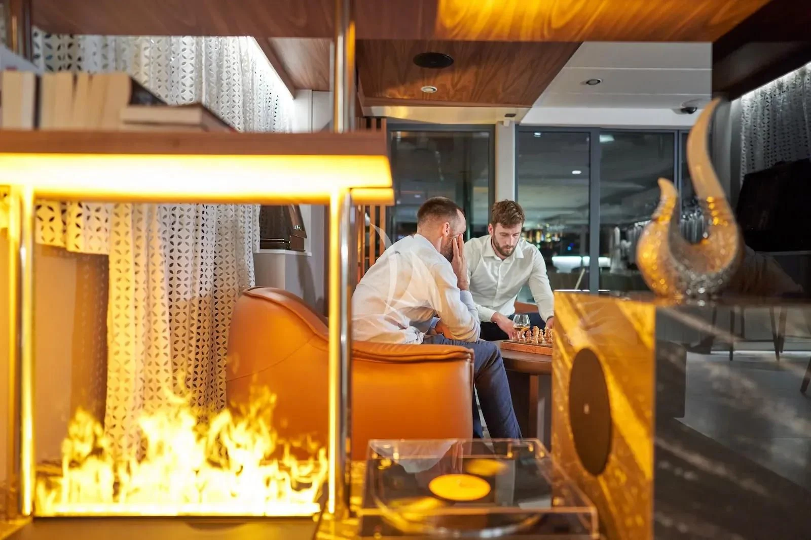 a couple of men sitting at a table in a restaurant aboard AETERNA Yacht for Sale