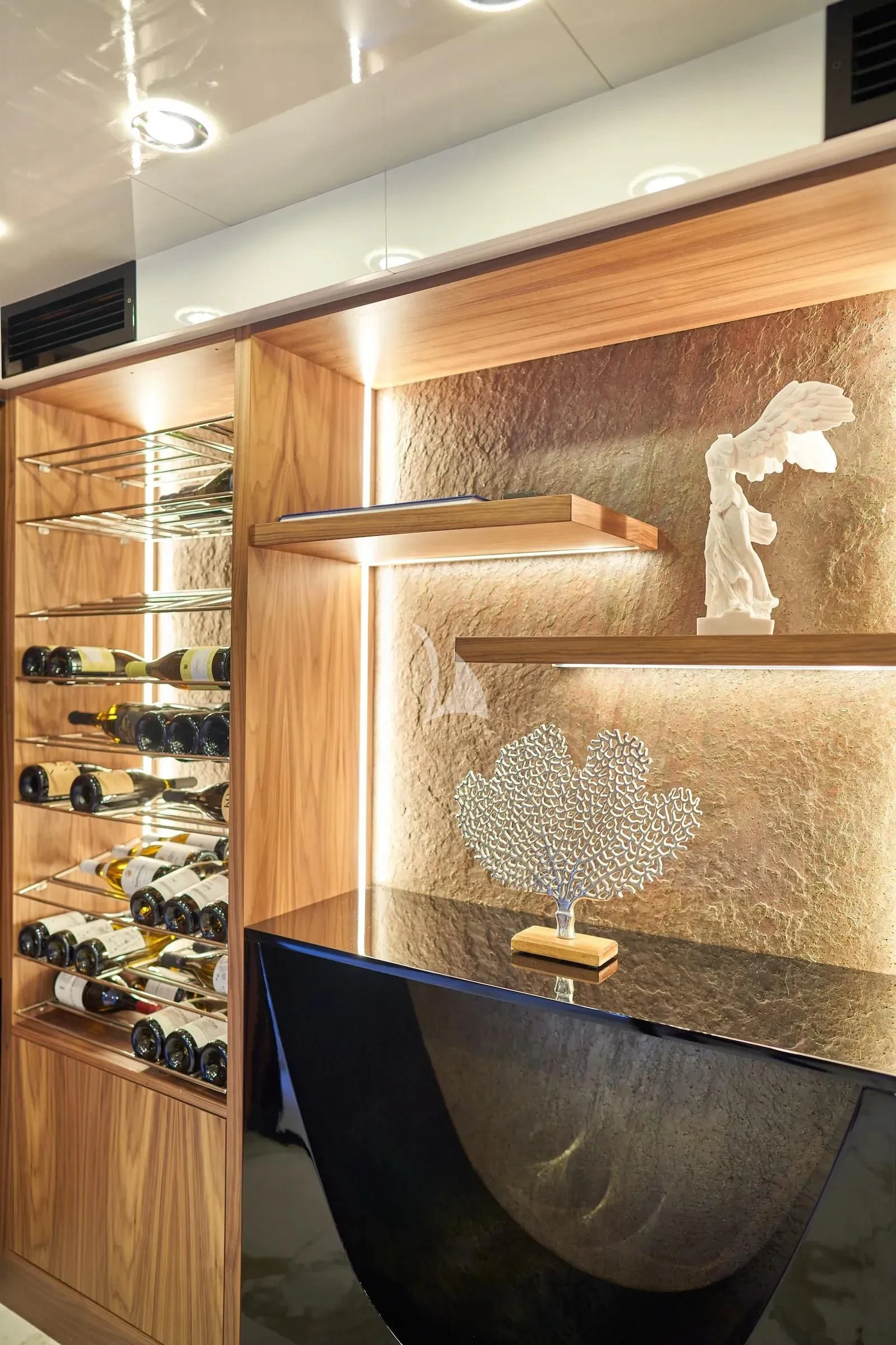 a room with a glass wall and a chandelier aboard AETERNA Yacht for Sale
