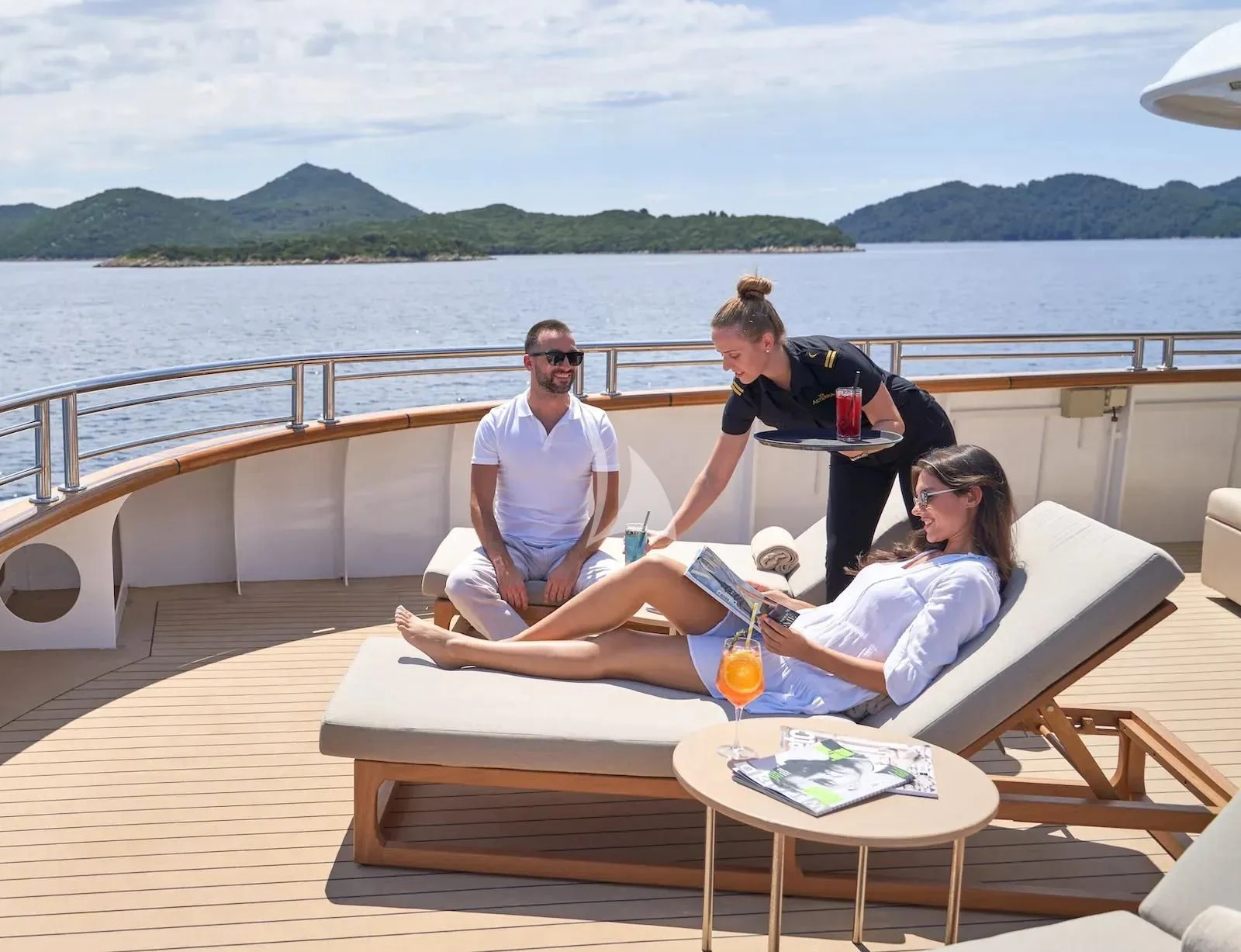 a group of people sitting on a dock on a boat aboard AETERNA Yacht for Sale