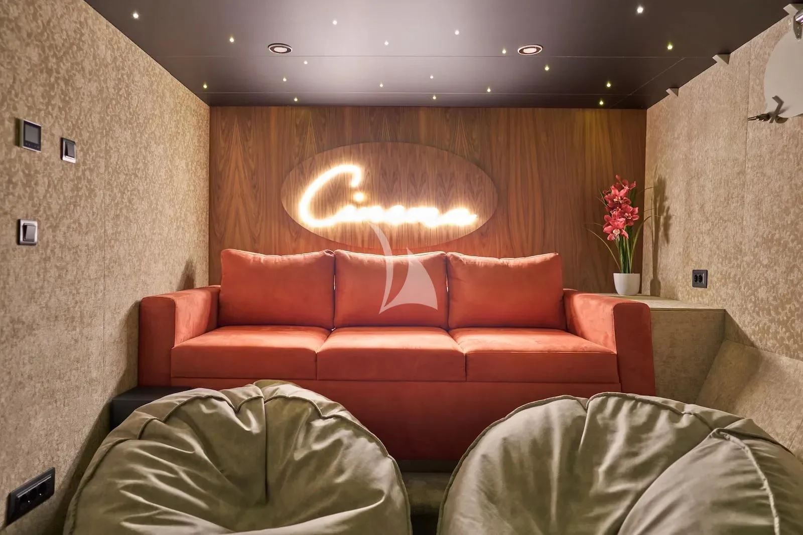 a room with a couch and a table with a lamp on it aboard AETERNA Yacht for Sale