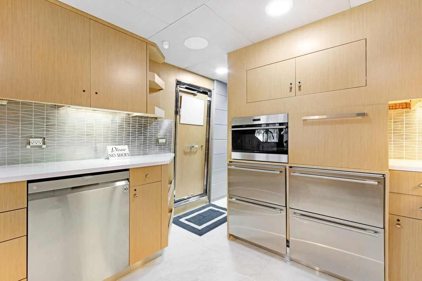 a kitchen with wooden cabinets aboard MARY KATHLENE Yacht for Sale