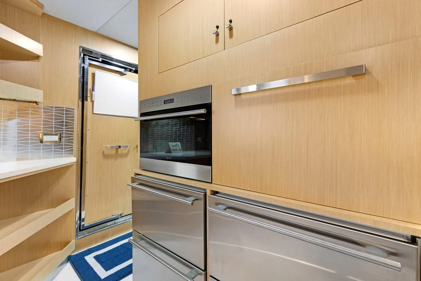 a kitchen with wooden cabinets aboard MARY KATHLENE Yacht for Sale