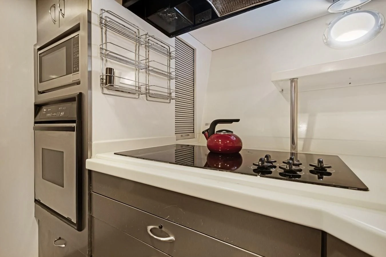 a red tea kettle on a stove aboard MARY KATHLENE Yacht for Sale