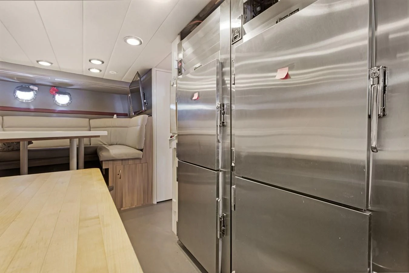 a room with a large wall of lockers and a table aboard MARY KATHLENE Yacht for Sale