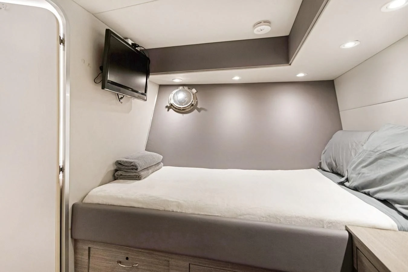 a bed with a television on the wall aboard MARY KATHLENE Yacht for Sale