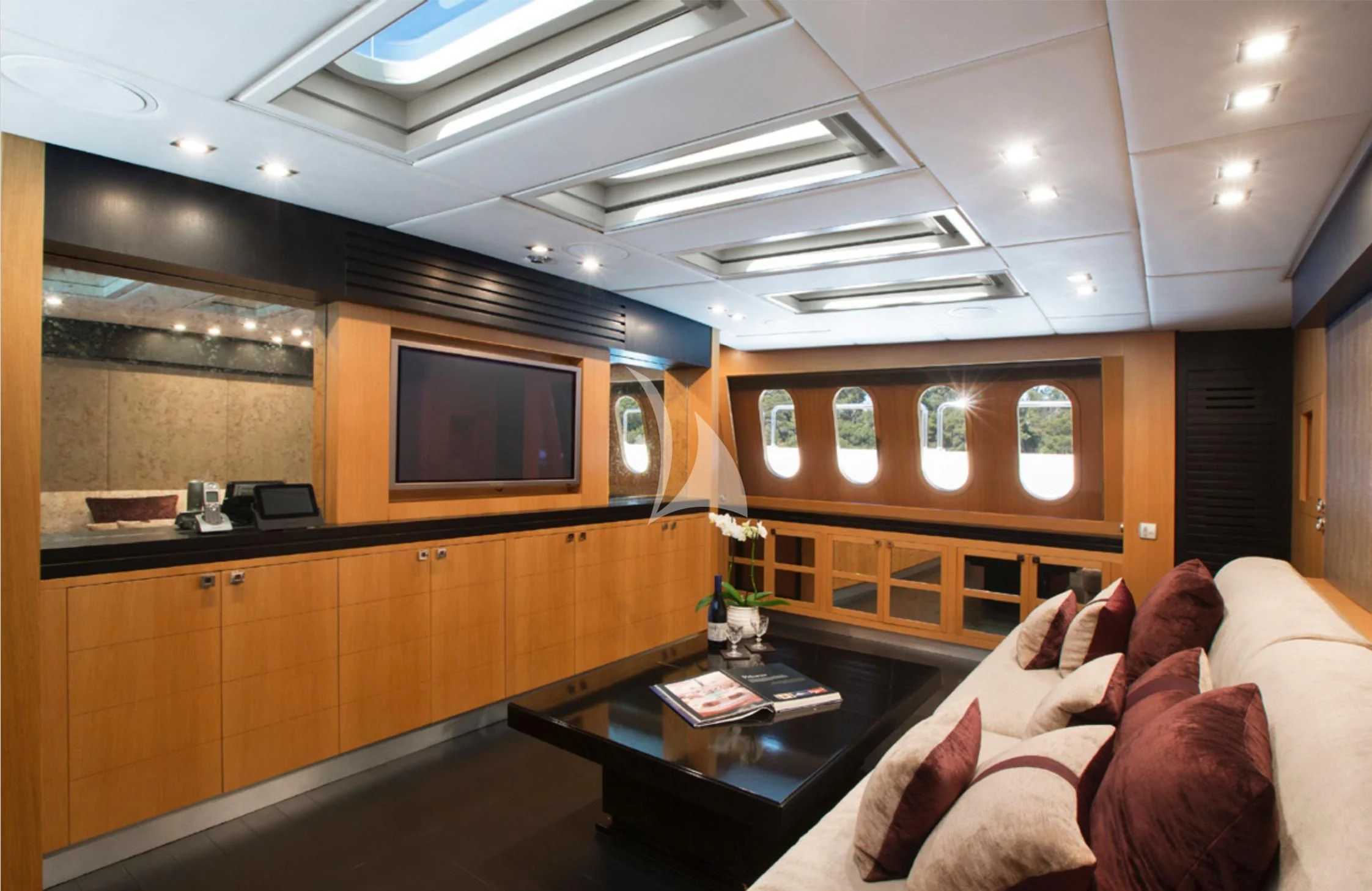 a living room with a couch and a tv aboard EOL B Yacht for Sale