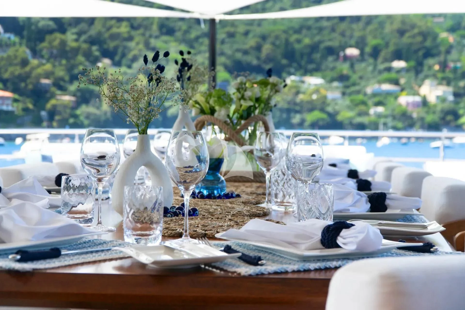 a table with wine glasses and plates aboard ETERNAL SPARK Yacht for Sale