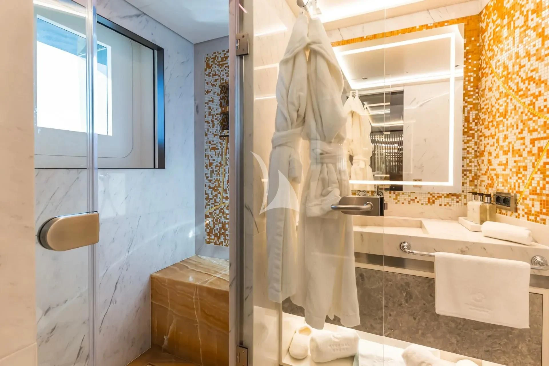 a bathroom with a robe on the wall aboard ETERNAL SPARK Yacht for Sale