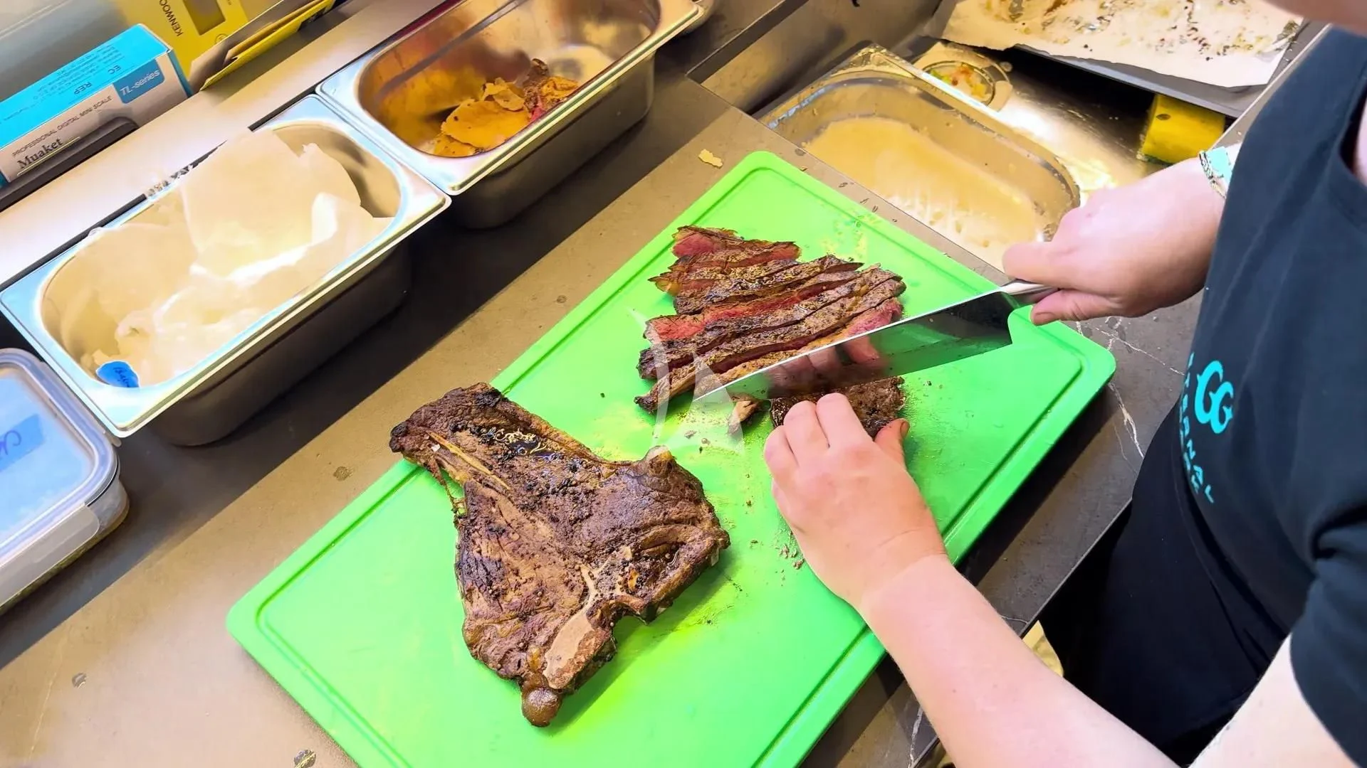 a person cutting meat on a cutting board aboard ETERNAL SPARK Yacht for Sale