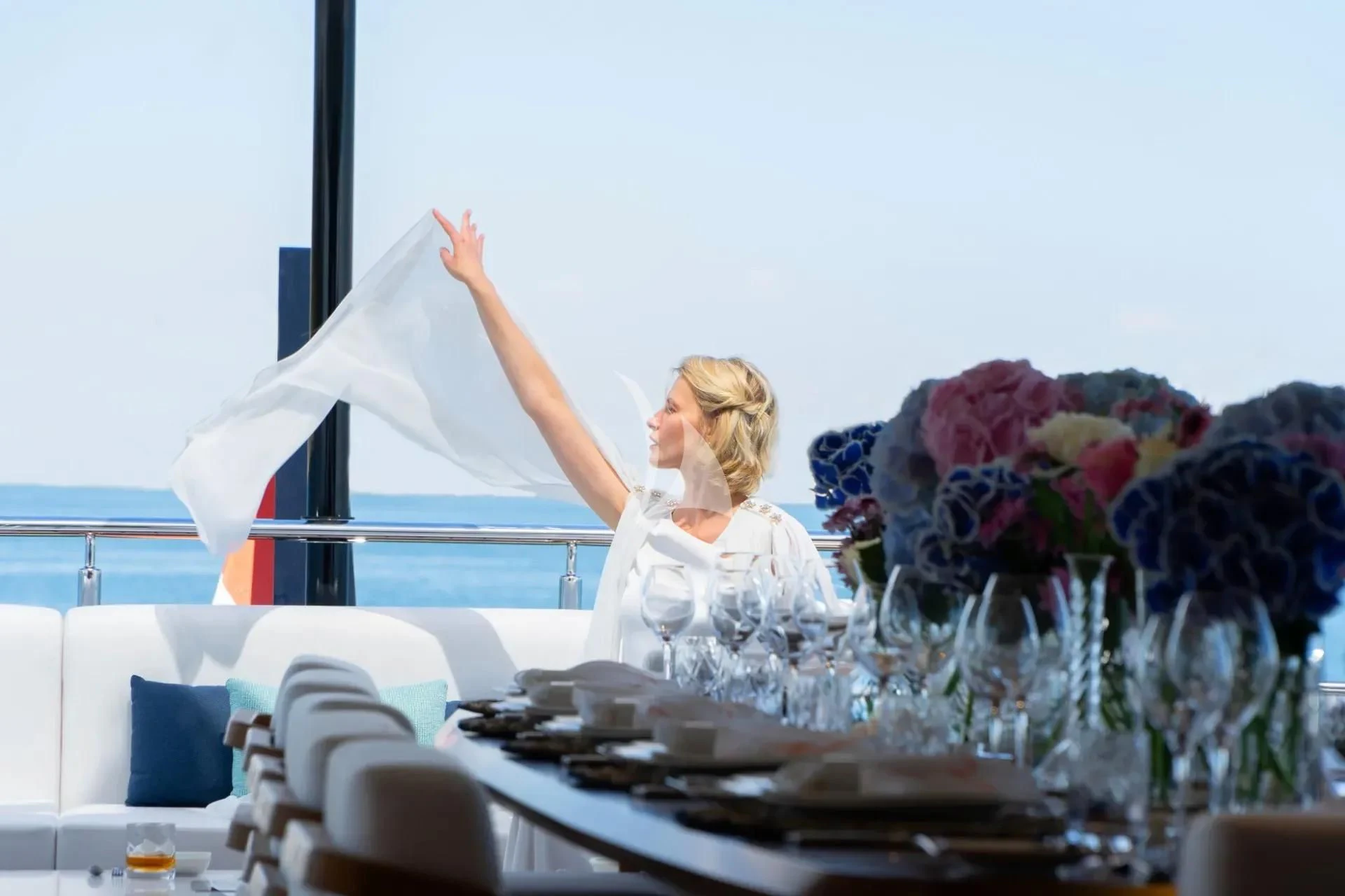 a person sitting at a table with a bouquet of flowers aboard ETERNAL SPARK Yacht for Sale