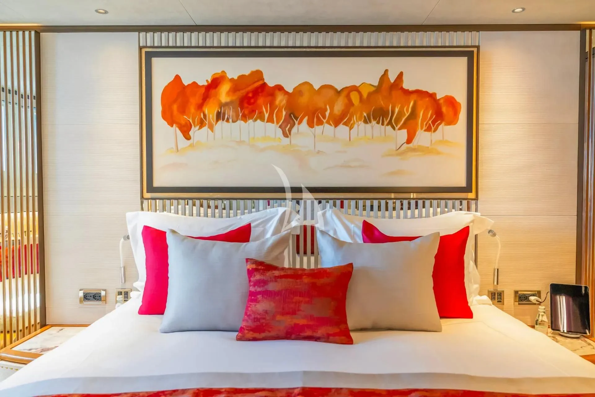 a bed with a painting on the wall aboard ETERNAL SPARK Yacht for Sale