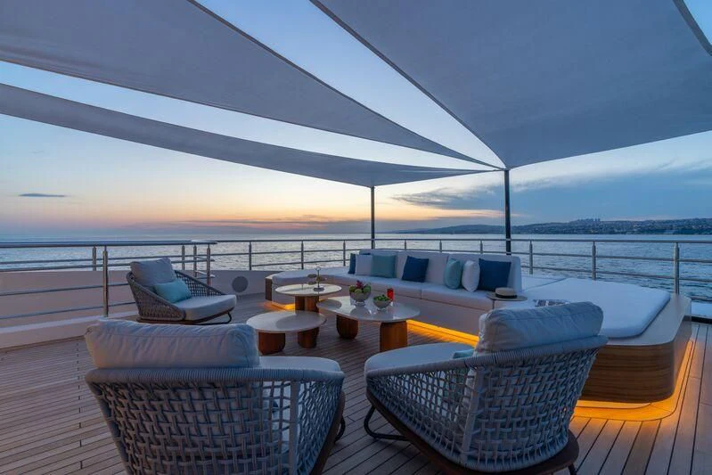 a patio with a table and chairs on it aboard ETERNAL SPARK Yacht for Sale