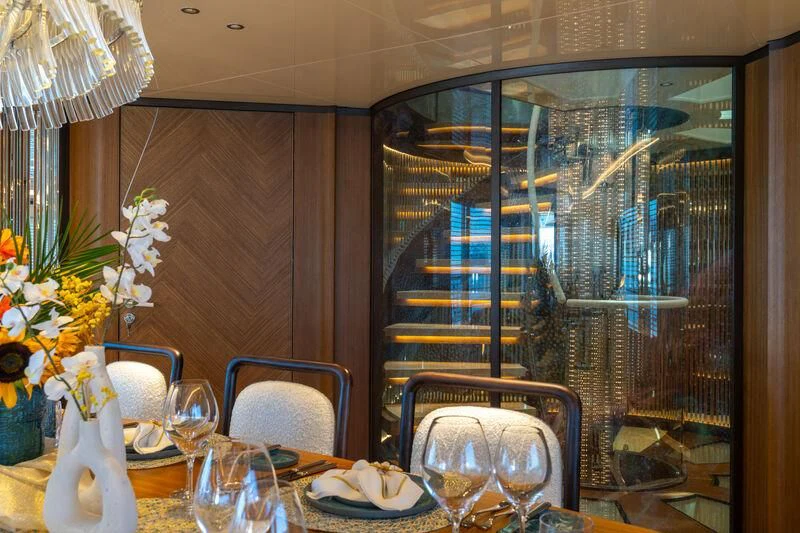 a dining room with a view of the city aboard ETERNAL SPARK Yacht for Sale