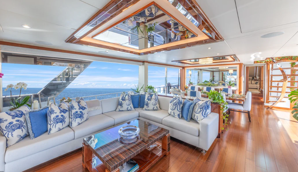 a living room with a large glass window aboard DRINKABILITY Yacht for Sale