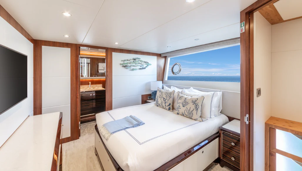 a large bedroom with a large bed aboard DRINKABILITY Yacht for Sale