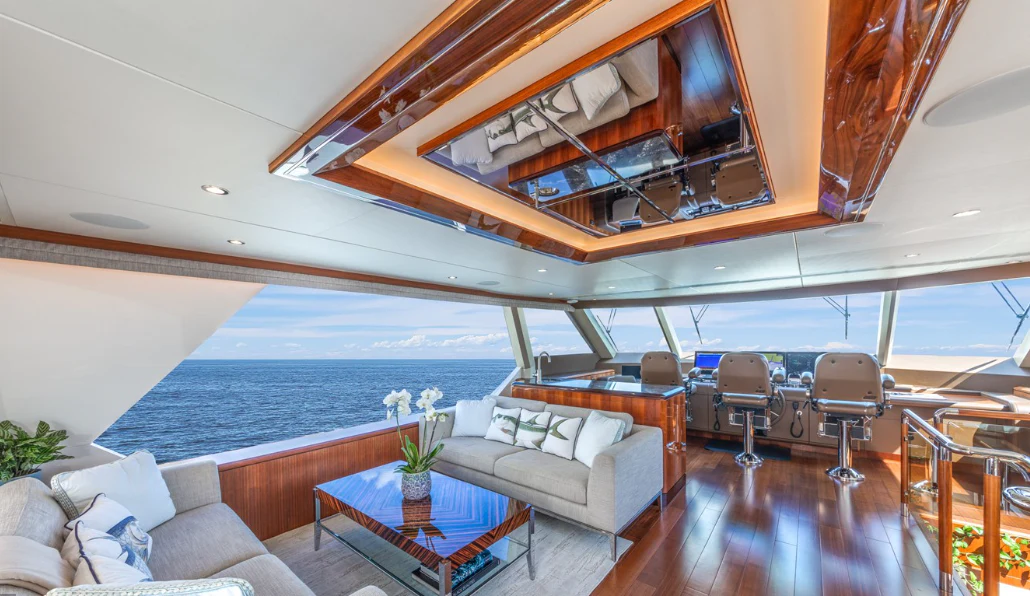 a room with a couch and a table and a pool aboard DRINKABILITY Yacht for Sale