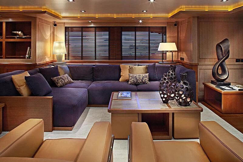 a living room with a couch and a coffee table aboard LADY I Yacht for Charter