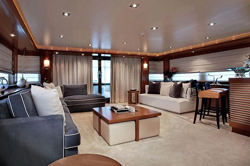 a living room with a couch and a coffee table aboard LADY I Yacht for Charter
