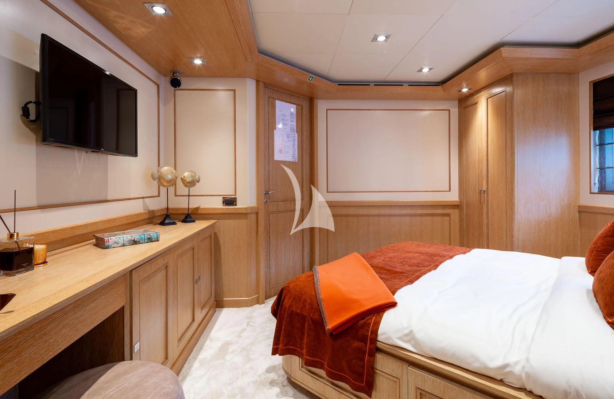 a bedroom with a desk and a bed aboard LADY I Yacht for Charter
