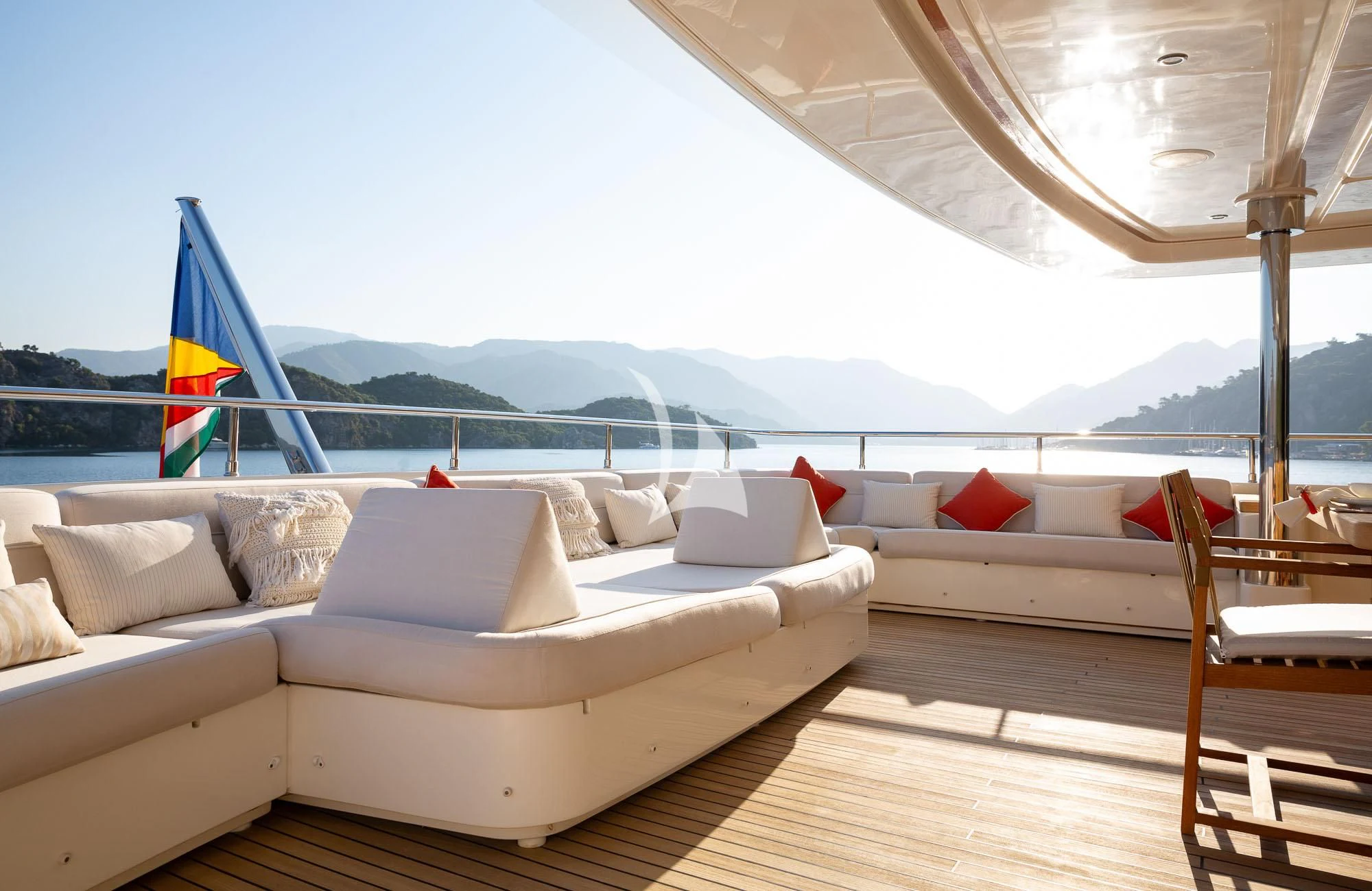 a large bed with a flag on it aboard LADY I Yacht for Charter