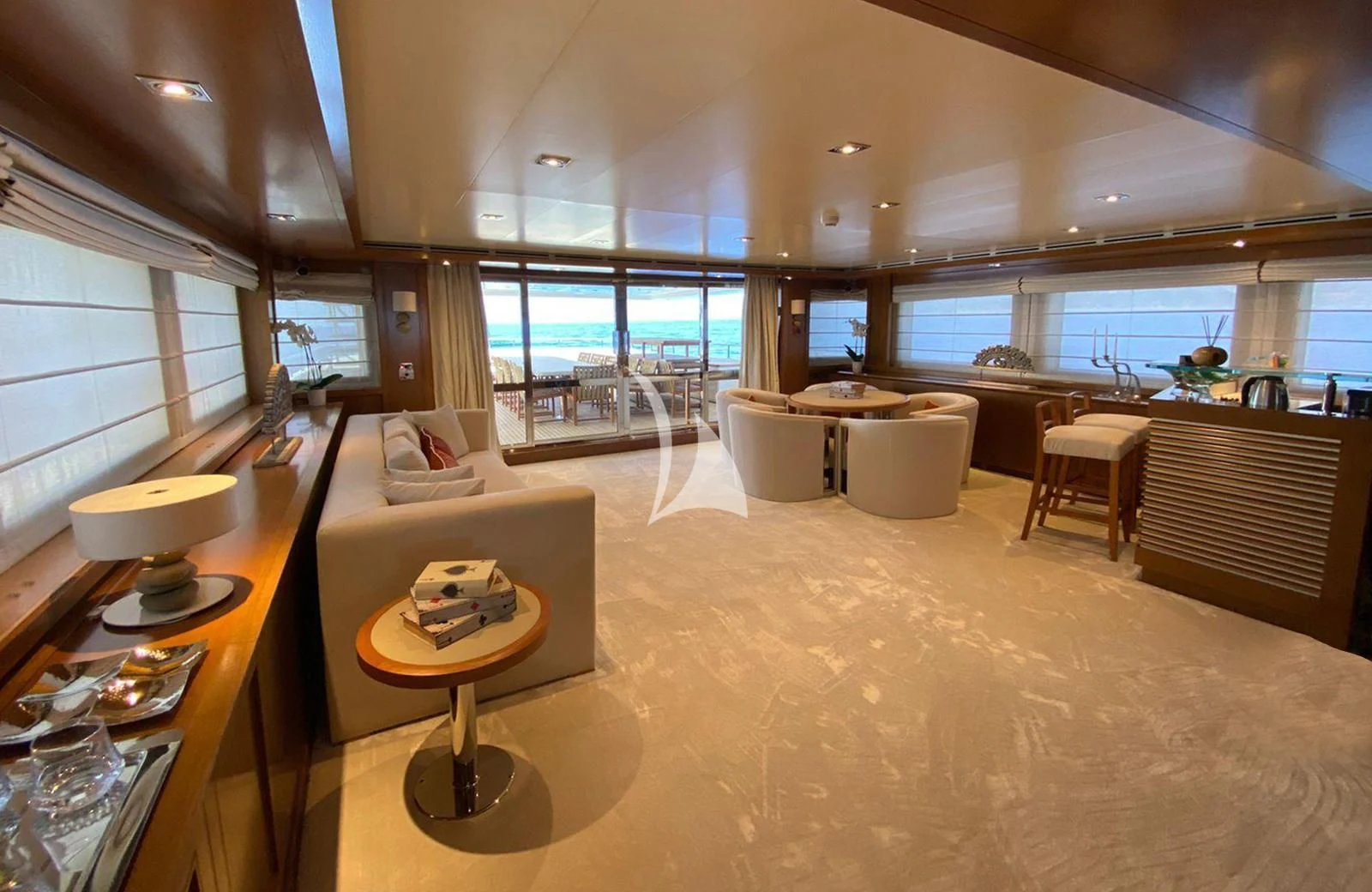a large living room with a large window aboard LADY I Yacht for Charter