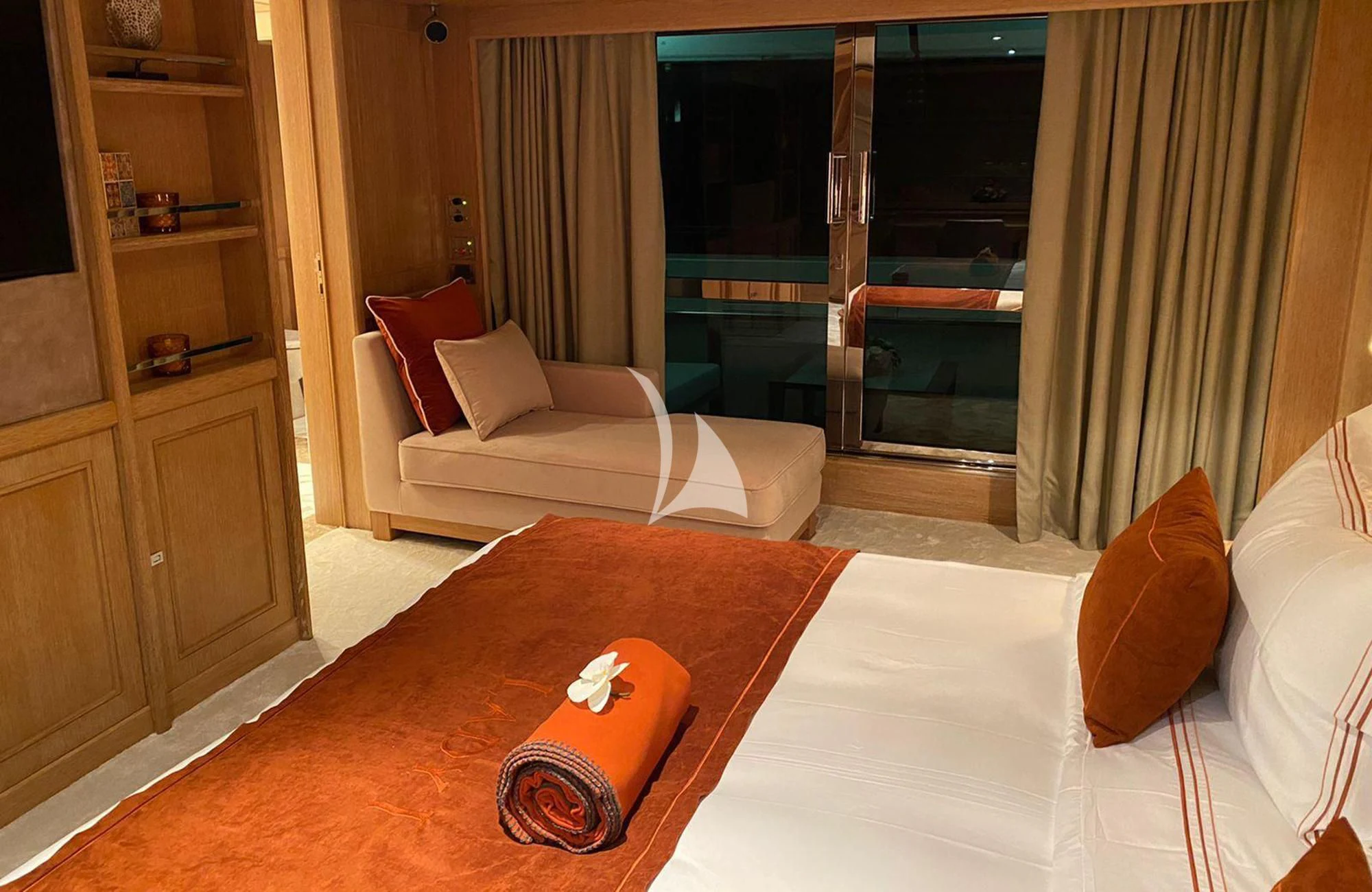 a room with a bed and a chair aboard LADY I Yacht for Charter