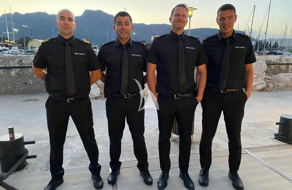 a group of men posing for a photo aboard LADY I Yacht for Charter