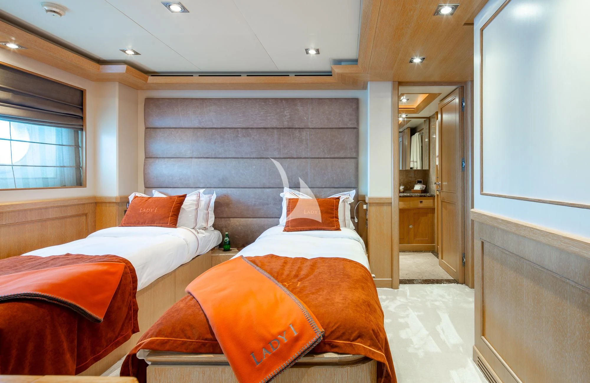 a room with a bed and a mirror aboard LADY I Yacht for Charter