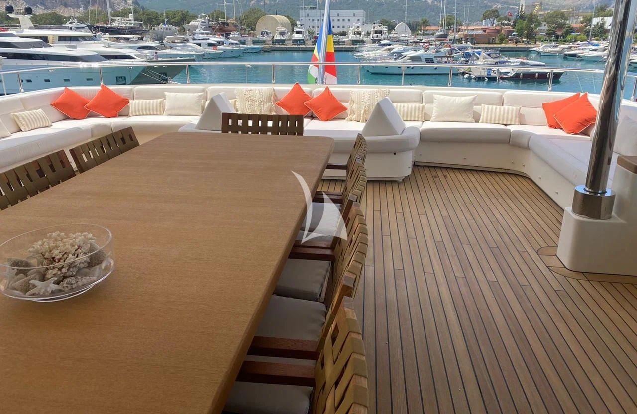 a wooden deck with chairs and tables aboard LADY I Yacht for Charter